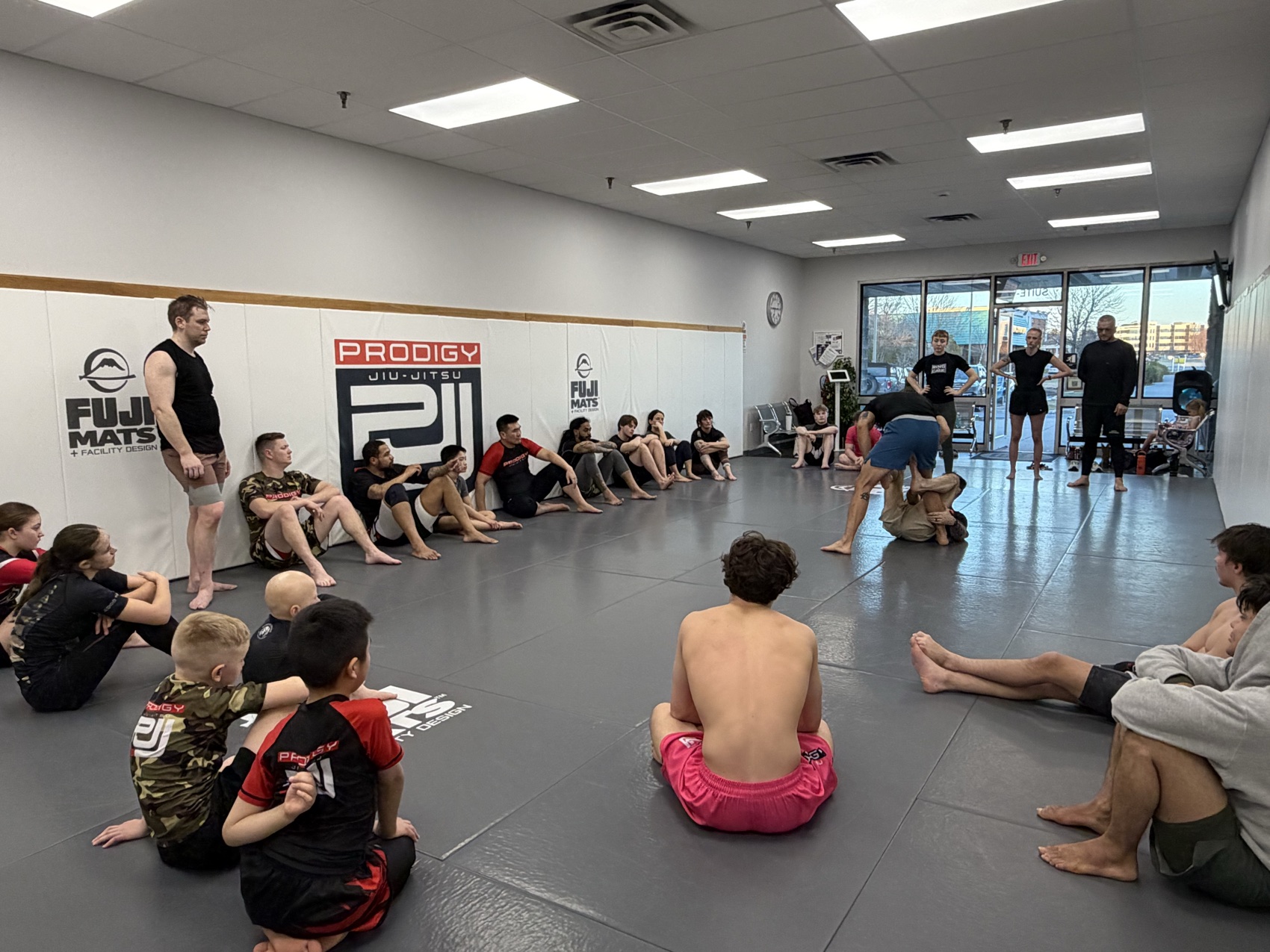 A full Prodigy Jiu-Jitsu class gathered around the mats at the academy in the Lehigh Valley