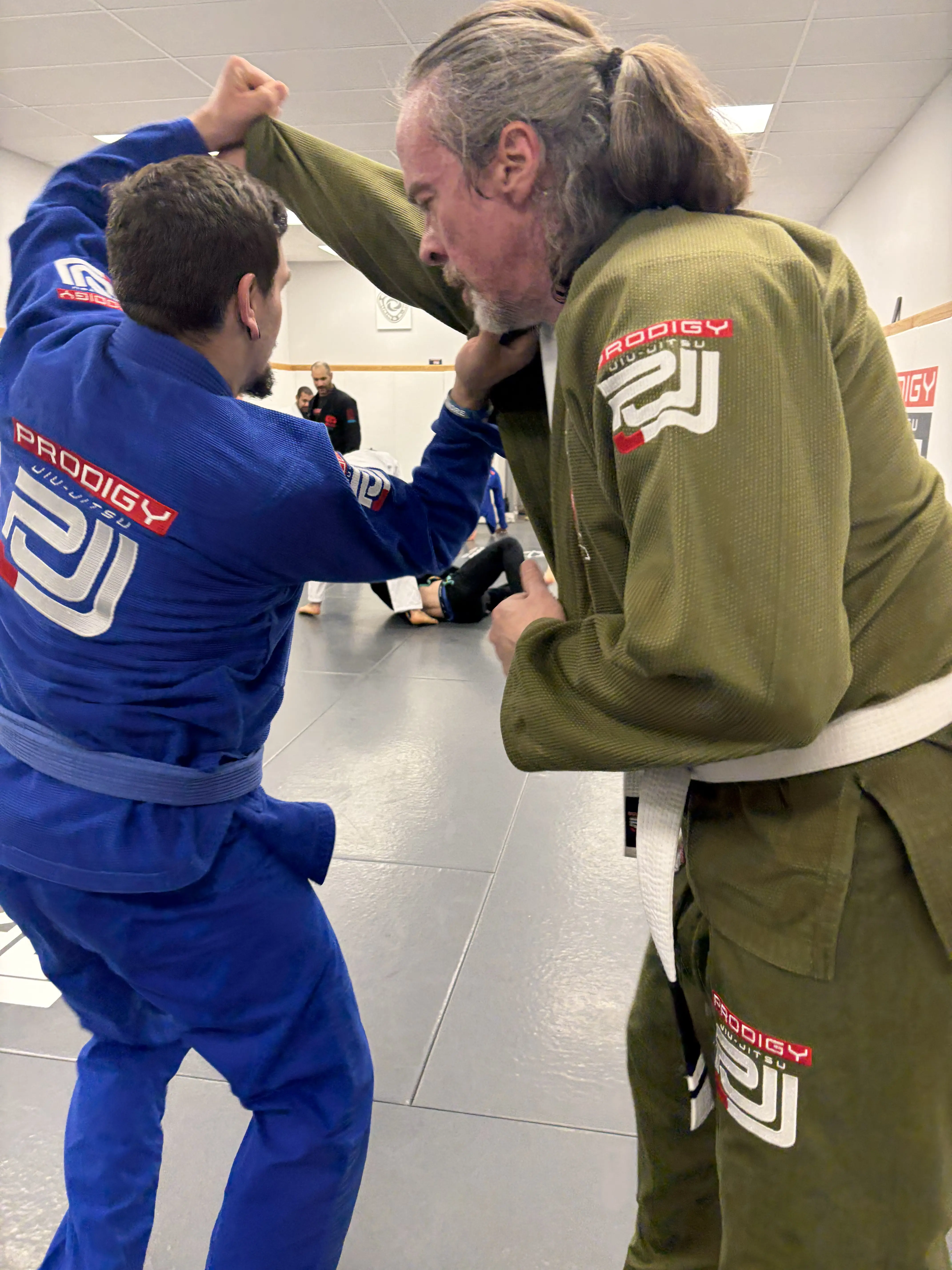 Adults grip fighting during a Gi Brazilian Jiu-Jitsu class at Prodigy in Fogelsville, PA
