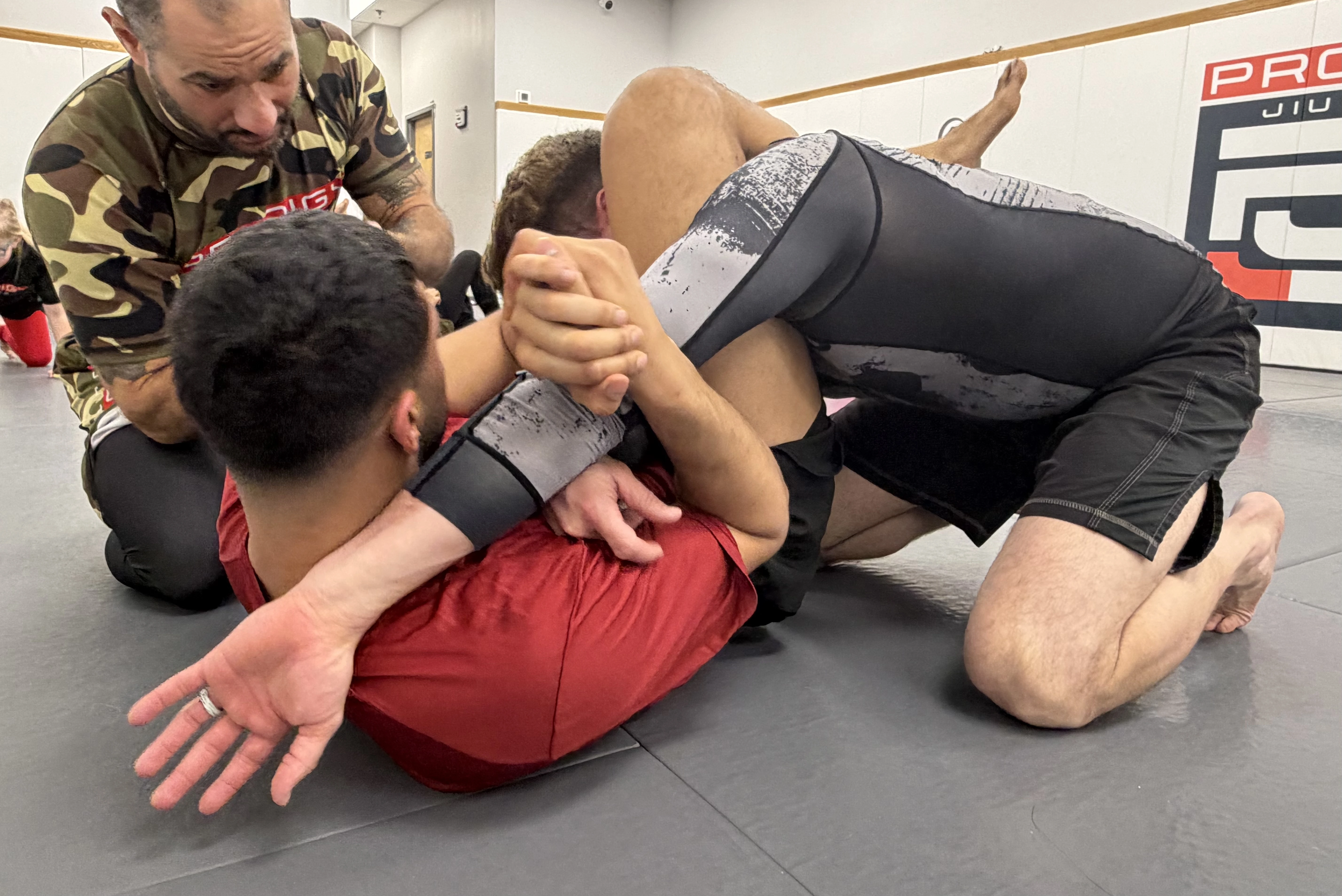 Coach drilling techniques with students at Prodigy Jiu-Jitsu