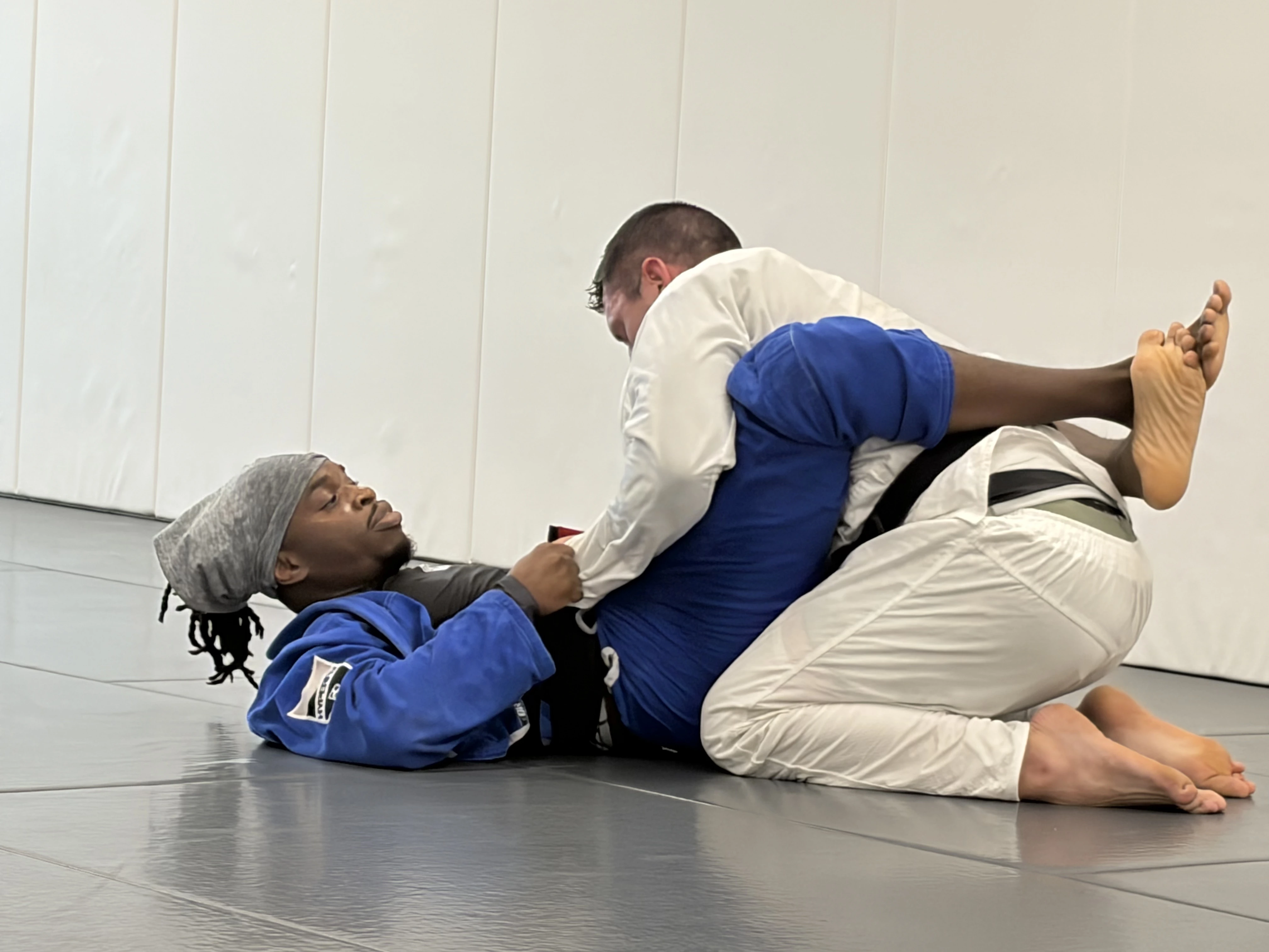 Adults rolling during a Gi Brazilian Jiu-Jitsu class at Prodigy in Fogelsville, PA